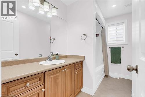 Full vanity with a single basin sink and a light-toned countertop - 92 Desoto Drive, Hamilton, ON - Indoor Photo Showing Bathroom