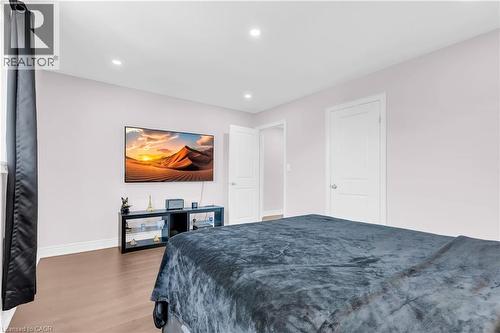Recessed ceiling lighting illuminates this room, featuring wood-finish flooring and light-toned walls - 92 Desoto Drive, Hamilton, ON - Indoor Photo Showing Bedroom