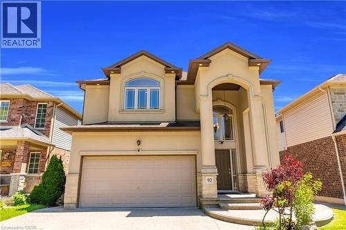 Stucco exterior with stone accents, featuring an arched portico entry - 92 Desoto Drive, Hamilton, ON - Outdoor With Facade