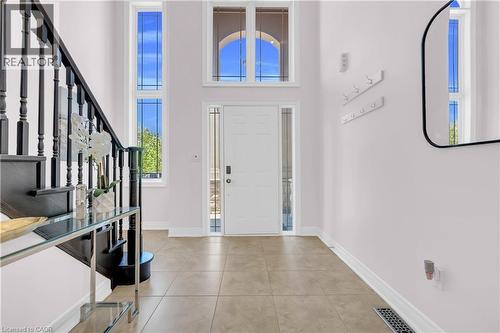 Foyer featuring a white entry door with frosted glass sidelights, transom window, and a grand two-story ceiling - 92 Desoto Drive, Hamilton, ON - Indoor Photo Showing Other Room