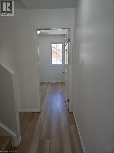 Hallway featuring wood-finish flooring, white painted walls, and a recessed ceiling light - 390 Wake Robin Crescent, Kitchener, ON - Indoor Photo Showing Other Room