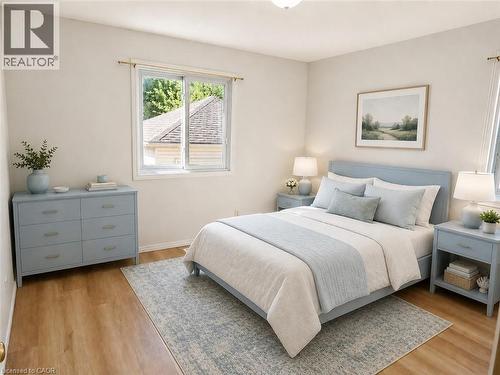 Bedroom featuring a window with a brass curtain rod, light-toned wall paint, wood-finish flooring, and a flush-mount ceiling light fixture - 390 Wake Robin Crescent, Kitchener, ON - Indoor Photo Showing Bedroom