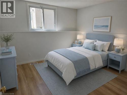 Bedroom featuring light wood-finish flooring, a contemporary white and light gray wall color scheme, and an egress window - 390 Wake Robin Crescent, Kitchener, ON - Indoor Photo Showing Bedroom