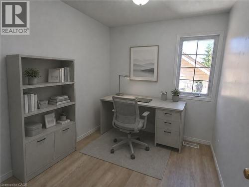 Dedicated room featuring light wood-finish flooring, white walls, and a large window with white trim - 390 Wake Robin Crescent, Kitchener, ON - Indoor Photo Showing Office
