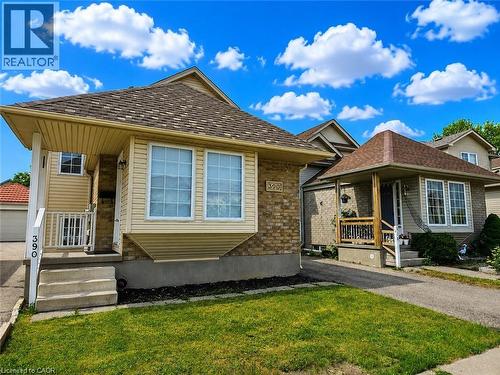 The property features a brick and siding exterior with a multi-toned shingle roof - 390 Wake Robin Crescent, Kitchener, ON - Outdoor With Facade