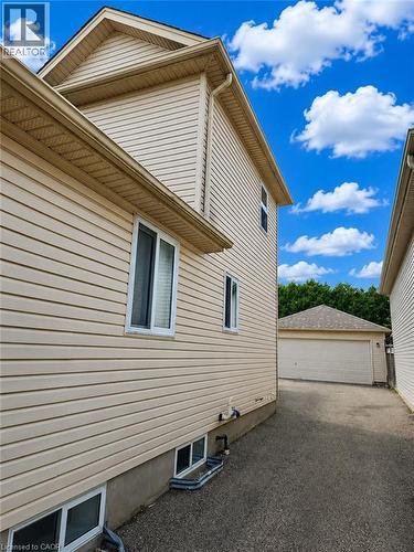 Cream-colored siding exterior with white window frames and a gabled roofline - 390 Wake Robin Crescent, Kitchener, ON - Outdoor With Exterior