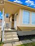 Property exterior featuring light-colored horizontal siding, brick accents, and a covered entryway - 390 Wake Robin Crescent, Kitchener, ON  - Outdoor 