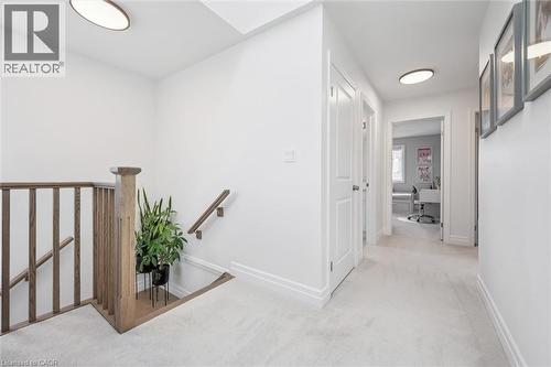 Upper-level hallway featuring light carpeting, white walls, and recessed lighting - 30 Waterbow Trail, Kitchener, ON - Indoor Photo Showing Other Room