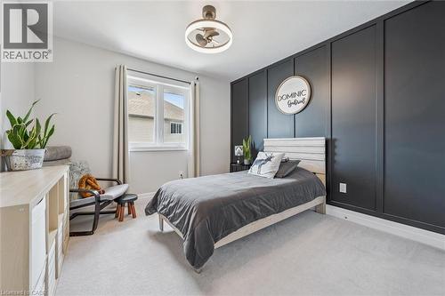Light gray carpeting complements a dark paneled accent wall - 30 Waterbow Trail, Kitchener, ON - Indoor Photo Showing Bedroom