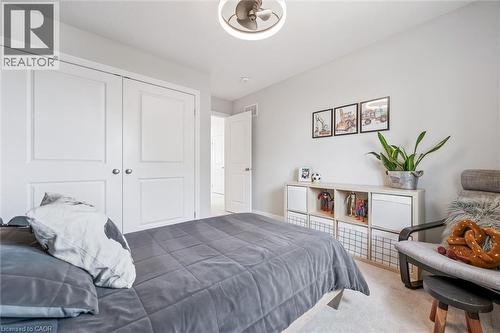 Light-toned wall paint and carpeting complement white trim throughout - 30 Waterbow Trail, Kitchener, ON - Indoor Photo Showing Bedroom