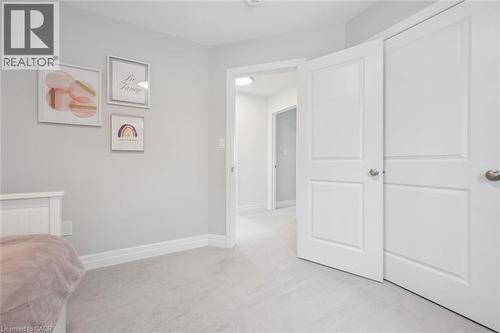 Interior room featuring light grey wall paint and light grey carpet flooring - 30 Waterbow Trail, Kitchener, ON - Indoor