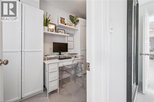 Built-in desk featuring white cabinetry, floating shelves, and recessed lighting - 30 Waterbow Trail, Kitchener, ON - Indoor
