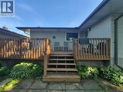 Multi-level wood deck with a full staircase, offering direct access to the exterior - 