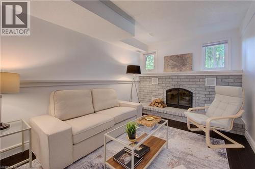Large windows make this room nice & bright - 375 Holiday Inn Drive Unit# 9, Cambridge, ON - Indoor Photo Showing Living Room With Fireplace