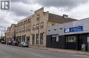 Commercial building featuring a brick facade with a stepped parapet roofline - 365 Colborne Street, Brantford, ON 
