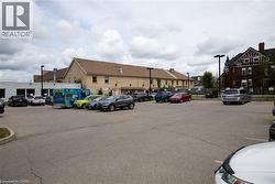 Expansive paved parking area with multiple parking spaces and perimeter lighting fixtures - 
