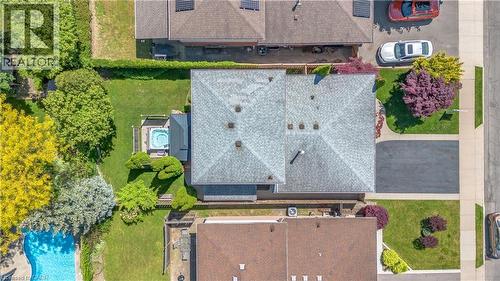 Shingled roofline with multiple ventilation caps and a central chimney - 640 Acadia Drive, Hamilton, ON 