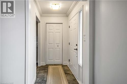 Entryway featuring slate-style flooring, white walls, and decorative crown molding - 640 Acadia Drive, Hamilton, ON 