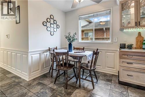 Ceramic tile flooring, white wainscoting, and a ceiling fan with integrated lighting - 640 Acadia Drive, Hamilton, ON 