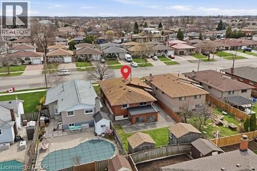 Brick two-story residence featuring a brown shingle roof and a concrete patio - 957 Stone Church Road E, Hamilton, ON - Outdoor With View