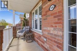 Brick exterior with white window frames and a covered front porch - 