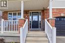 Brick facade entry with a dark paneled front door featuring a divided light window - 136 Carpenter Road, Cambridge, ON  - Outdoor With Exterior 