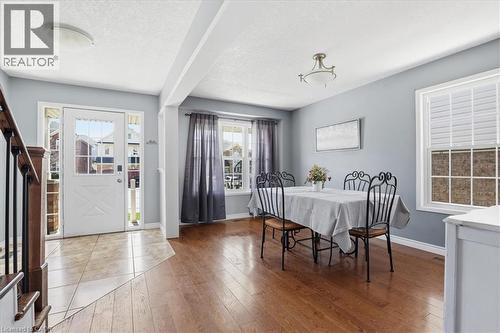 Foyer featuring light-toned tile flooring and a white entry door with frosted glass panes - 136 Carpenter Road, Cambridge, ON - Indoor Photo Showing Bathroom