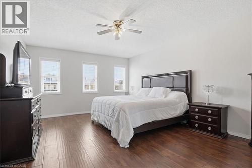 Spacious room featuring wood-finish flooring, three windows with blinds, a ceiling fan with integrated lighting, and light-toned walls - 136 Carpenter Road, Cambridge, ON - Indoor Photo Showing Bathroom