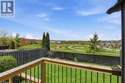 Outdoor balcony featuring wood railing with black metal balusters - 