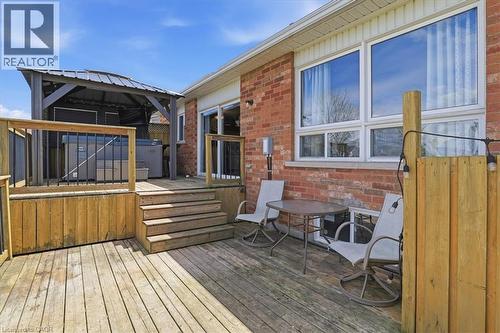 Multi-level wood deck featuring a covered gazebo, built-in hot tub, and direct access to interior spaces through a sliding glass door - 136 Carpenter Road, Cambridge, ON - Outdoor