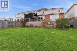 Expansive lawn area featuring a multi-level wood deck with a dark-tone gazebo - 