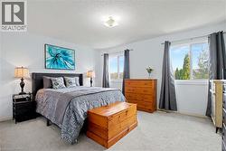 Bright bedroom with light wall paint and recessed ceiling light fixture - 
