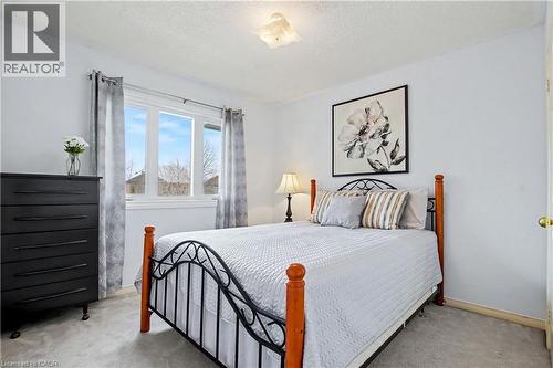 Bedroom featuring light gray wall paint, window with white trim, and gray carpeted flooring - 236 Fitzgerald Crescent, Milton, ON - Indoor Photo Showing Bedroom