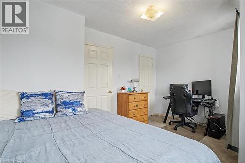 Carpeted bedroom featuring white painted walls and a ceiling-mounted light fixture - 236 Fitzgerald Crescent, Milton, ON - Indoor Photo Showing Bedroom