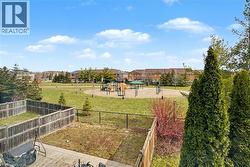 Outdoor space featuring a fenced yard with a paver patio and a partially fenced grass area - 