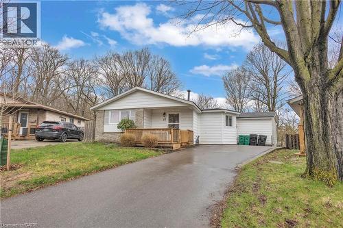 Ranch-style residence featuring a brick and siding facade, a front wooden deck, and a paved driveway leading to an attached garage - 22 Blackhorne Crescent, Kitchener, ON - Outdoor With Deck Patio Veranda With Facade