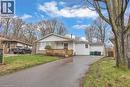 Ranch-style residence featuring a brick and siding facade, a front wooden deck, and a paved driveway leading to an attached garage - 22 Blackhorne Crescent, Kitchener, ON  - Outdoor With Deck Patio Veranda With Facade 