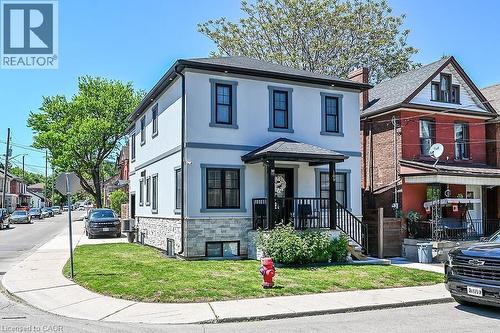 Contemporary two-story residence featuring a light-colored stucco exterior with dark trim accents - 109 Ray Street N, Hamilton, ON - Outdoor With Facade