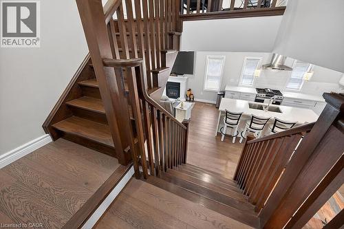 Rich wood-finish staircase with open balusters - 109 Ray Street N, Hamilton, ON - Indoor Photo Showing Other Room