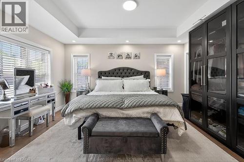 Spacious room featuring tray ceiling, recessed lighting, and wood-finish flooring - 109 Ray Street N, Hamilton, ON - Indoor Photo Showing Bedroom