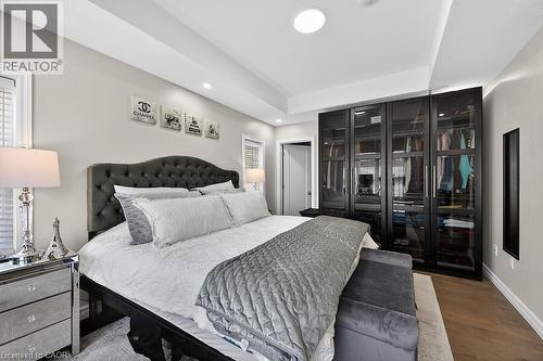 Bedroom featuring a tray ceiling, recessed lighting, and wood-finish flooring - 109 Ray Street N, Hamilton, ON - Indoor Photo Showing Bedroom
