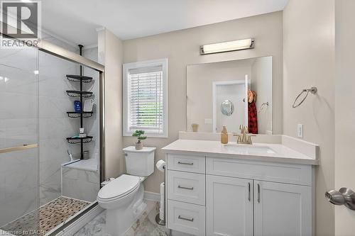 White vanity with a quartz countertop, an undermount sink, and a large wall-mounted mirror - 109 Ray Street N, Hamilton, ON - Indoor Photo Showing Bathroom