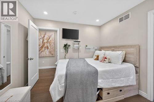 Bedroom featuring wood-finish flooring, recessed lighting, and a wall-mounted ventilation system - 109 Ray Street N, Hamilton, ON - Indoor Photo Showing Bedroom