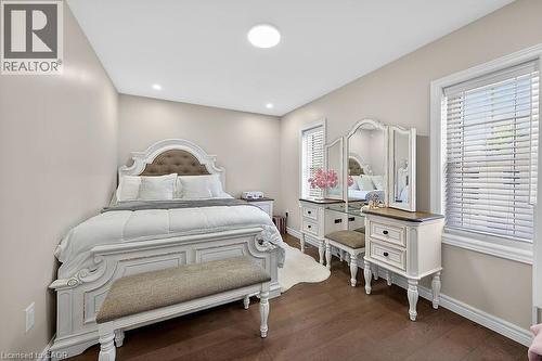 Hardwood-finish flooring complements the neutral wall tones - 109 Ray Street N, Hamilton, ON - Indoor Photo Showing Bedroom