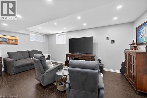 Recessed lighting illuminates this open room with wood-finish flooring - 109 Ray Street N, Hamilton, ON - Indoor Photo Showing Basement