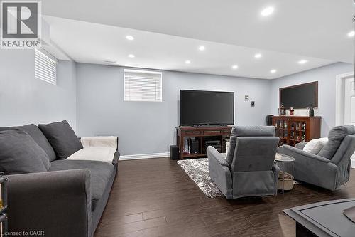 Recreation room featuring recessed lighting, light-colored walls, dark wood-finish flooring, and white trim - 109 Ray Street N, Hamilton, ON - Indoor Photo Showing Basement