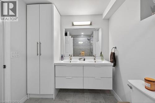 Modern bathroom featuring a double vanity with two rectangular vessel sinks, under-sink storage drawers, and a large wall-mounted mirror - 109 Ray Street N, Hamilton, ON - Indoor Photo Showing Bathroom