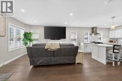 Open-concept living space featuring wood-finish flooring and recessed lighting - 