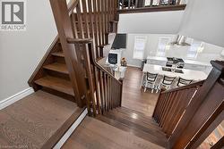 Rich wood-finish staircase with open balusters - 