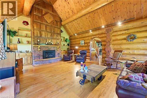 Vaulted wood-finish ceilings and walls create a warm ambiance - 169 James Street, Atwood, ON - Indoor With Fireplace